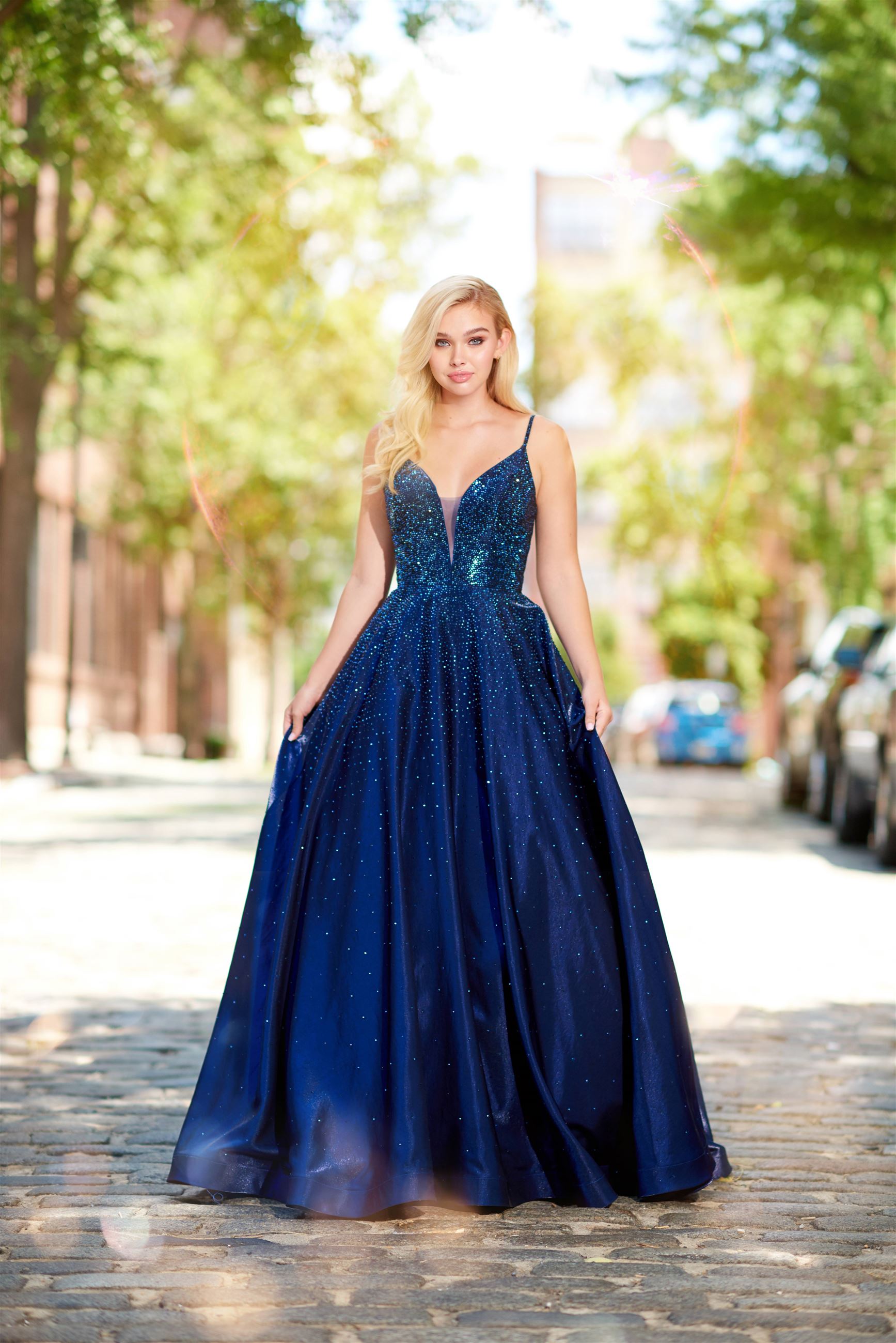 Girl wearing navy blue prom dress with sequin details by Ellie Wilde