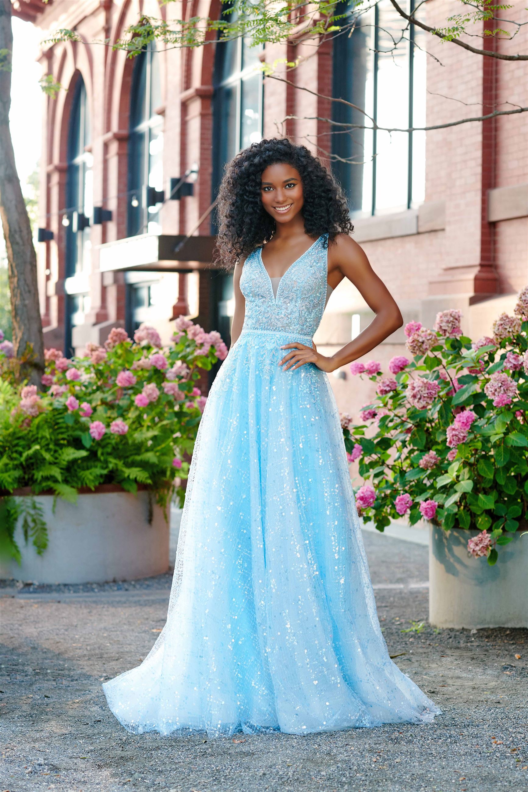 Girl wearing sparkly blue prom dress by Ellie Wilde