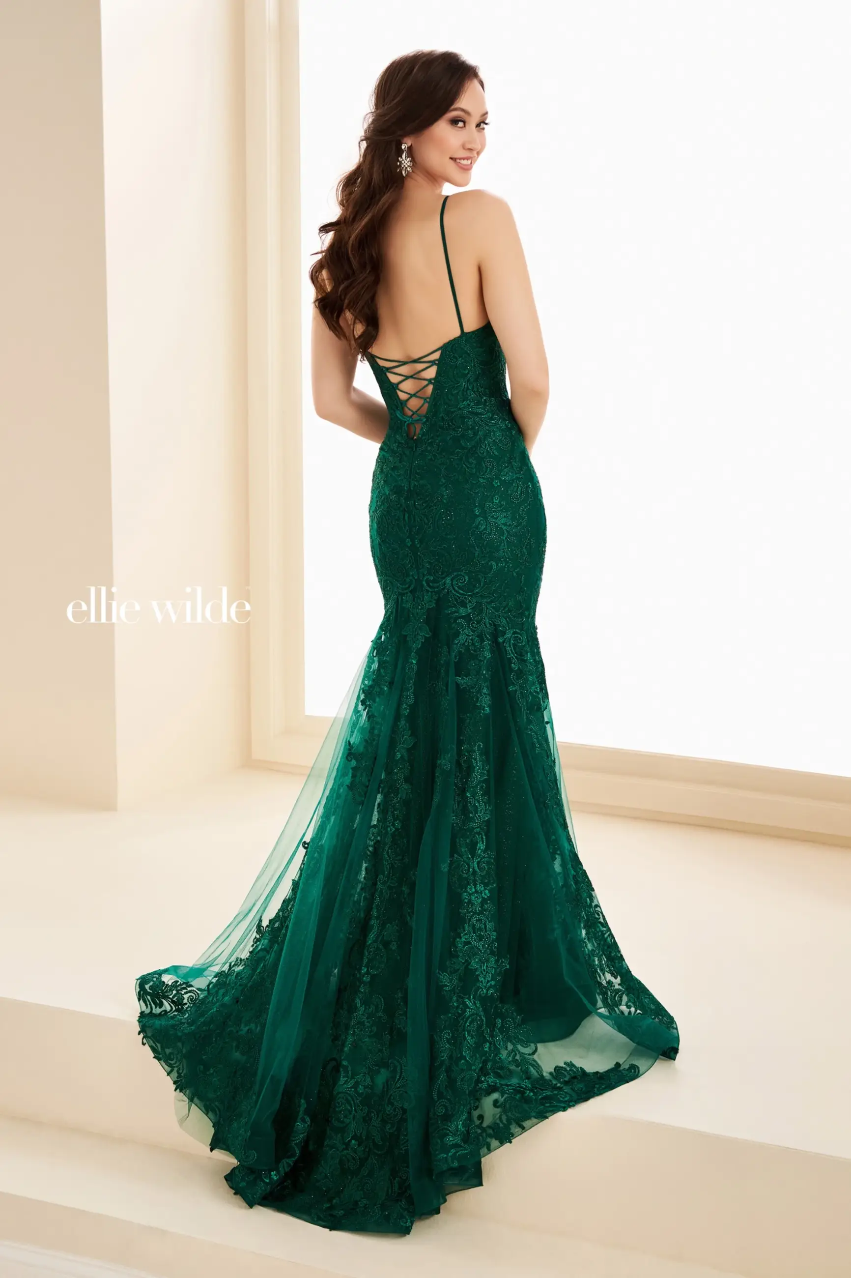 model is wearing a green sleeveless prom dress