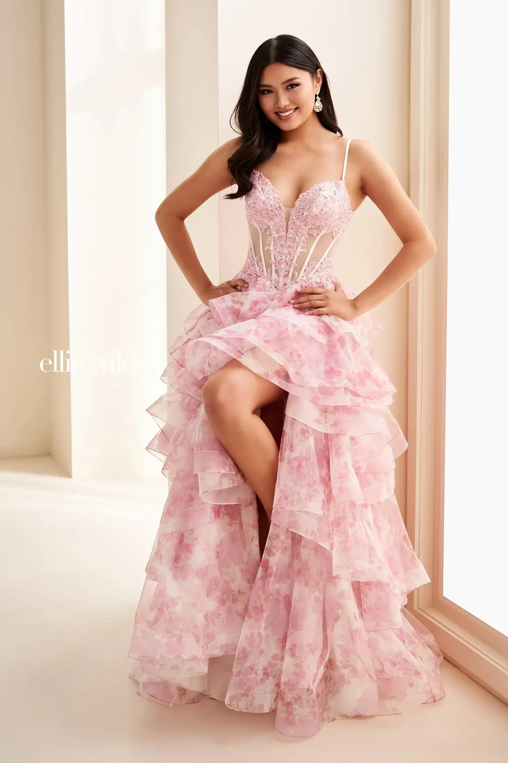Model is wearing a floral ball gown prom dress with floral lace and sparkles